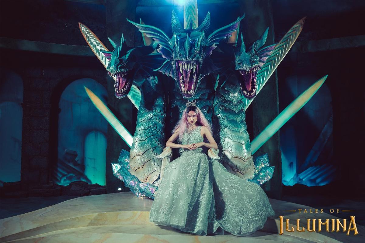 isang babaeng nakaupo sa ibabaw ng isang dragon statue