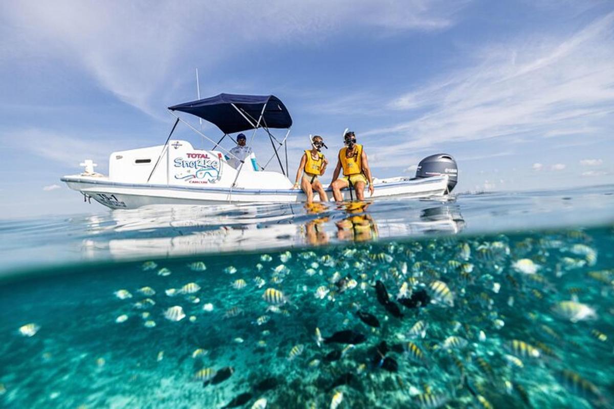 three people are standing on a boat in the ocean