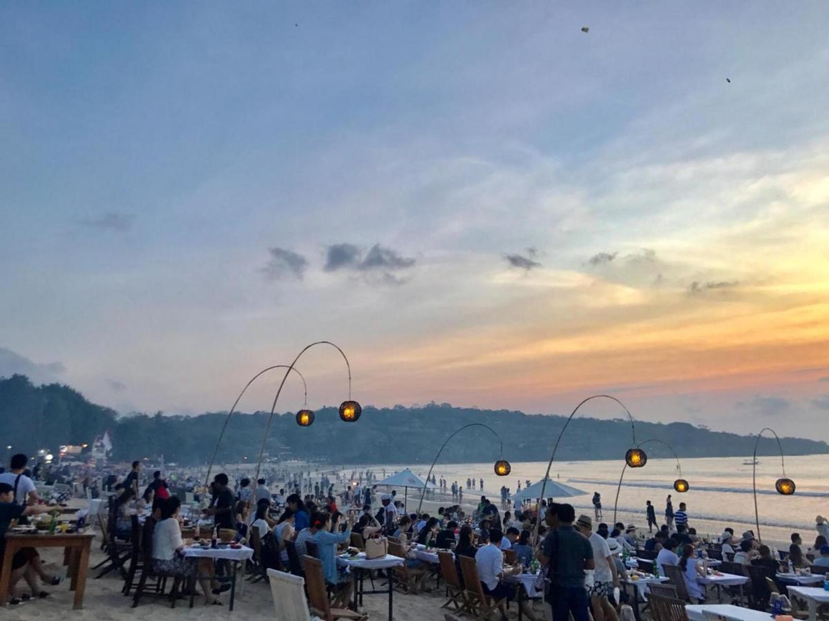 a crowd of people sitting at tables at a party