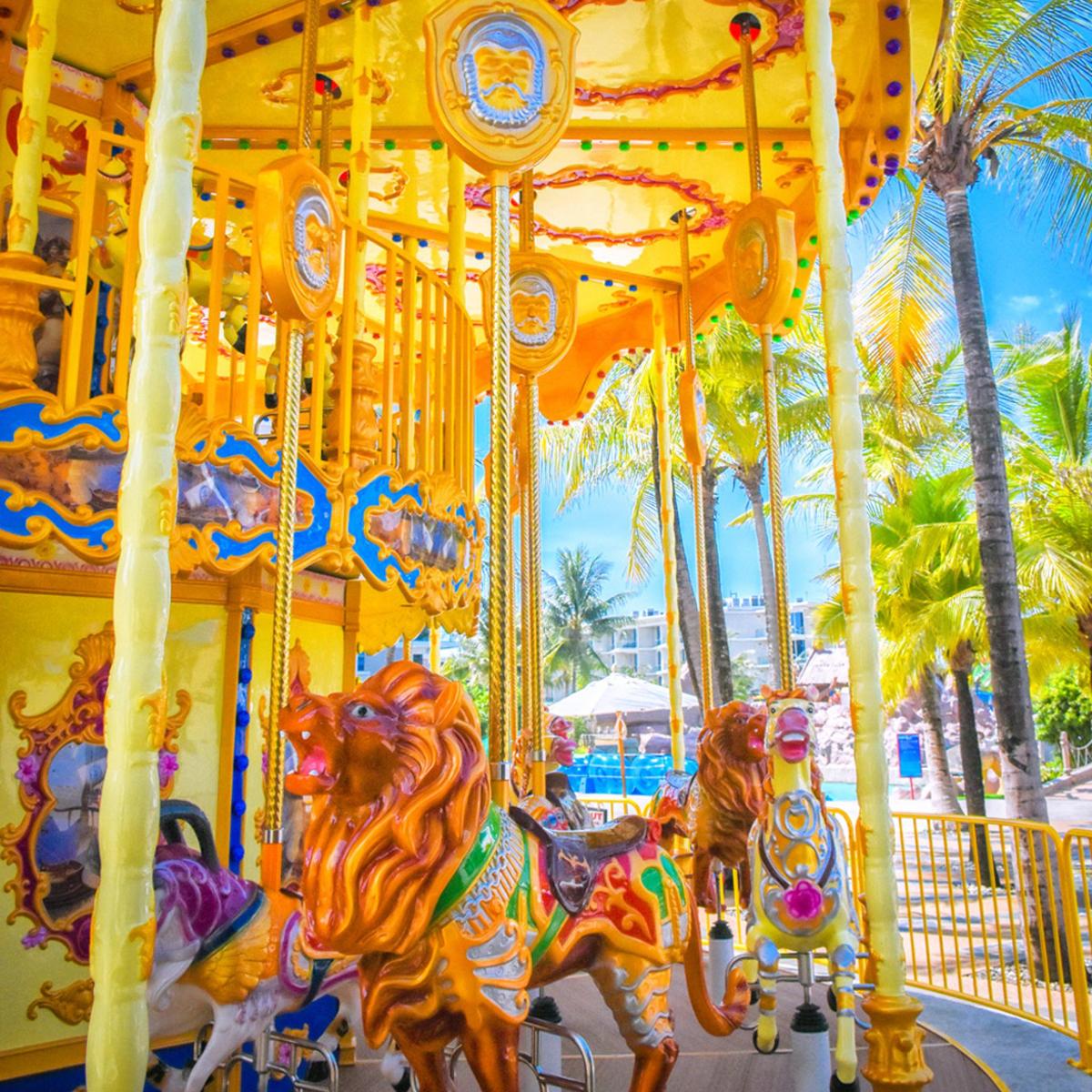a group of horses on a carousel at a carnival