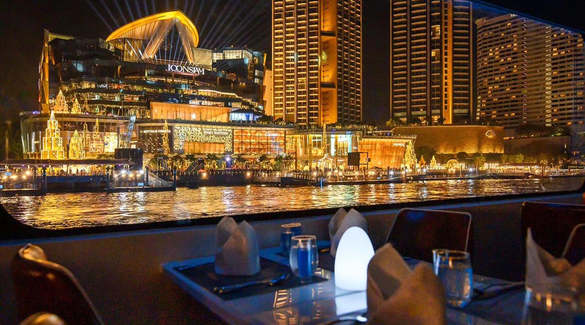 a restaurant with a view of a city at night