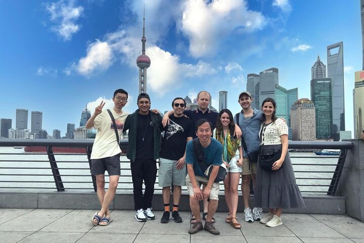 a group of people posing for a picture in front of a city