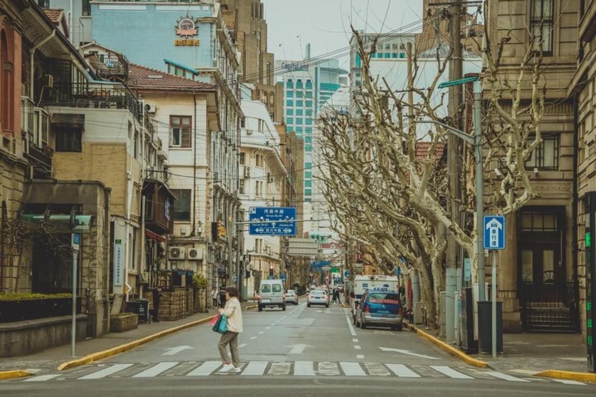 a woman crossing a street in a city