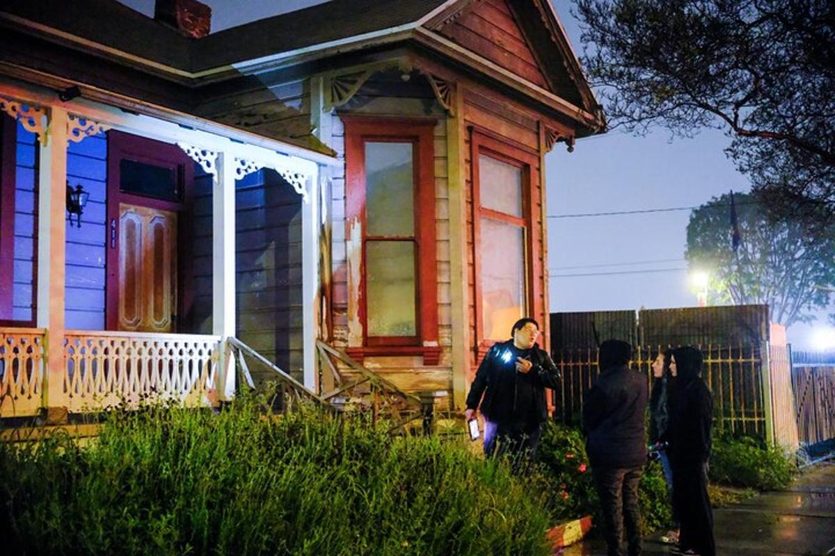 a group of people standing in front of a house