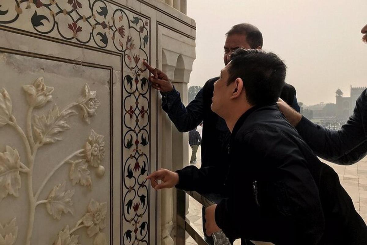 a group of people working on a metal door