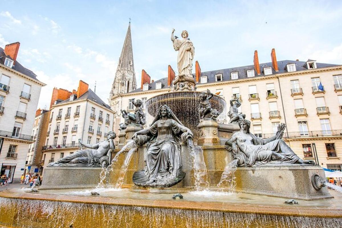 a fountain with a statue in the middle of a city