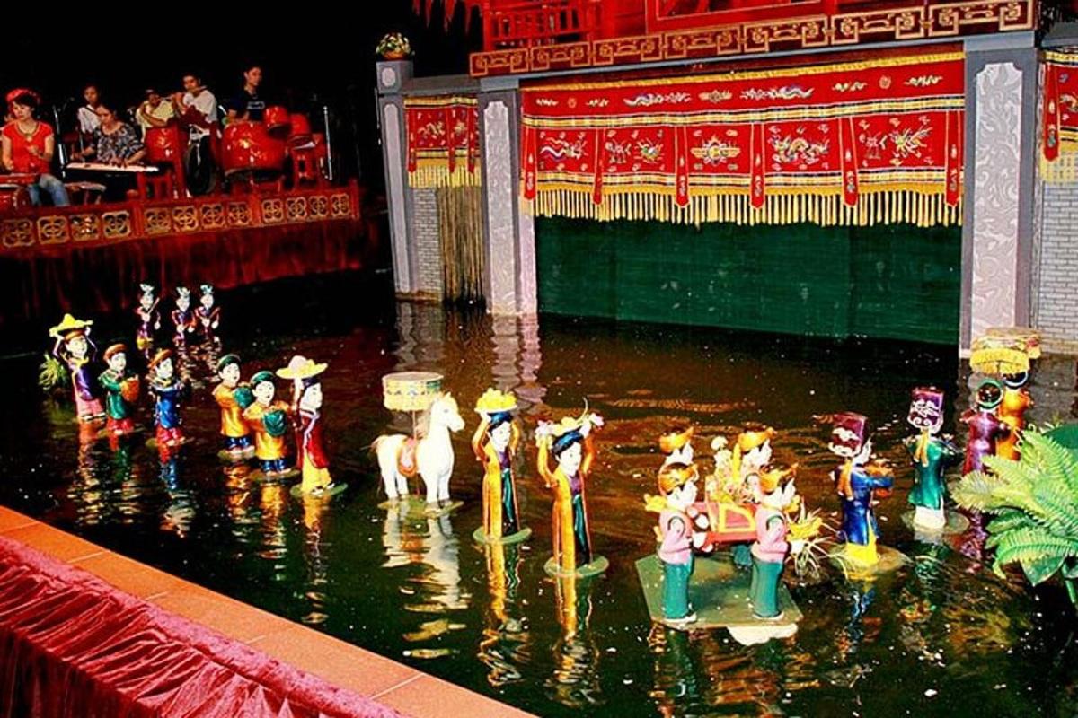 a group of people in the water in front of a stage