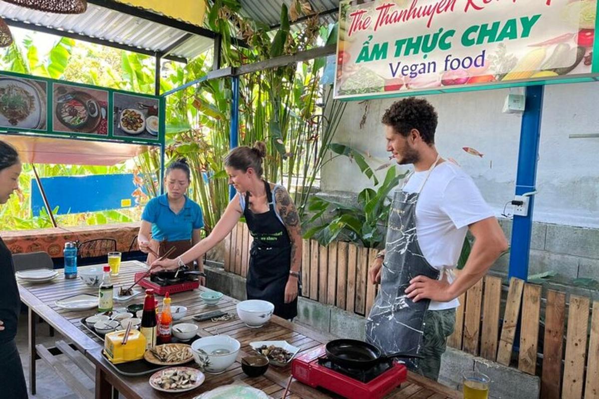 a group of people standing around a table preparing food