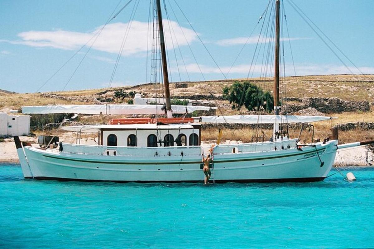 a white boat sitting in the blue water