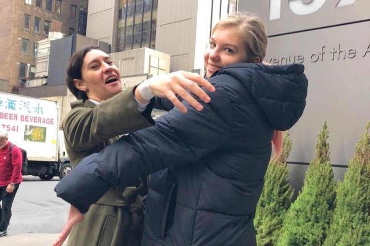 a man hugging a woman in front of a building