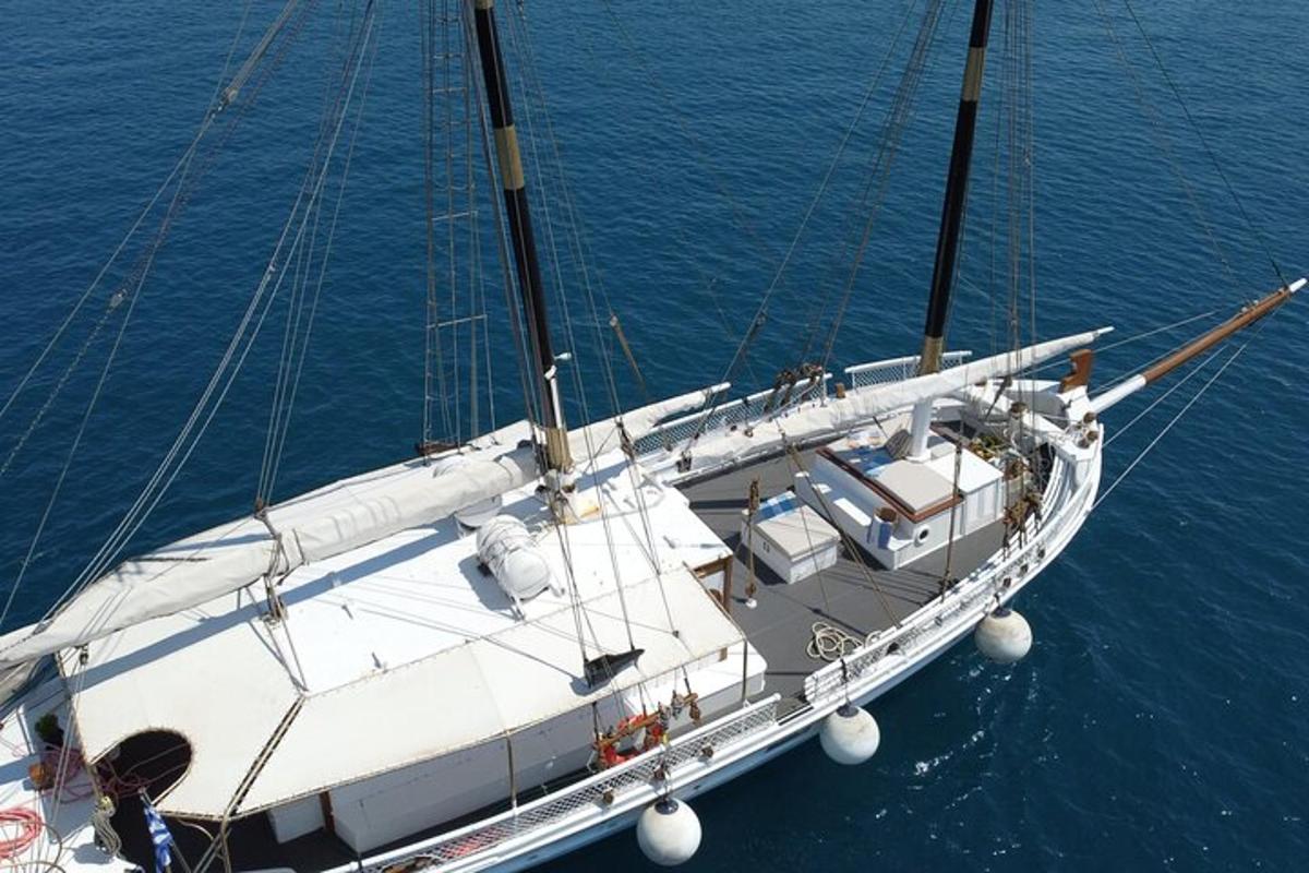 a white boat is docked in the water