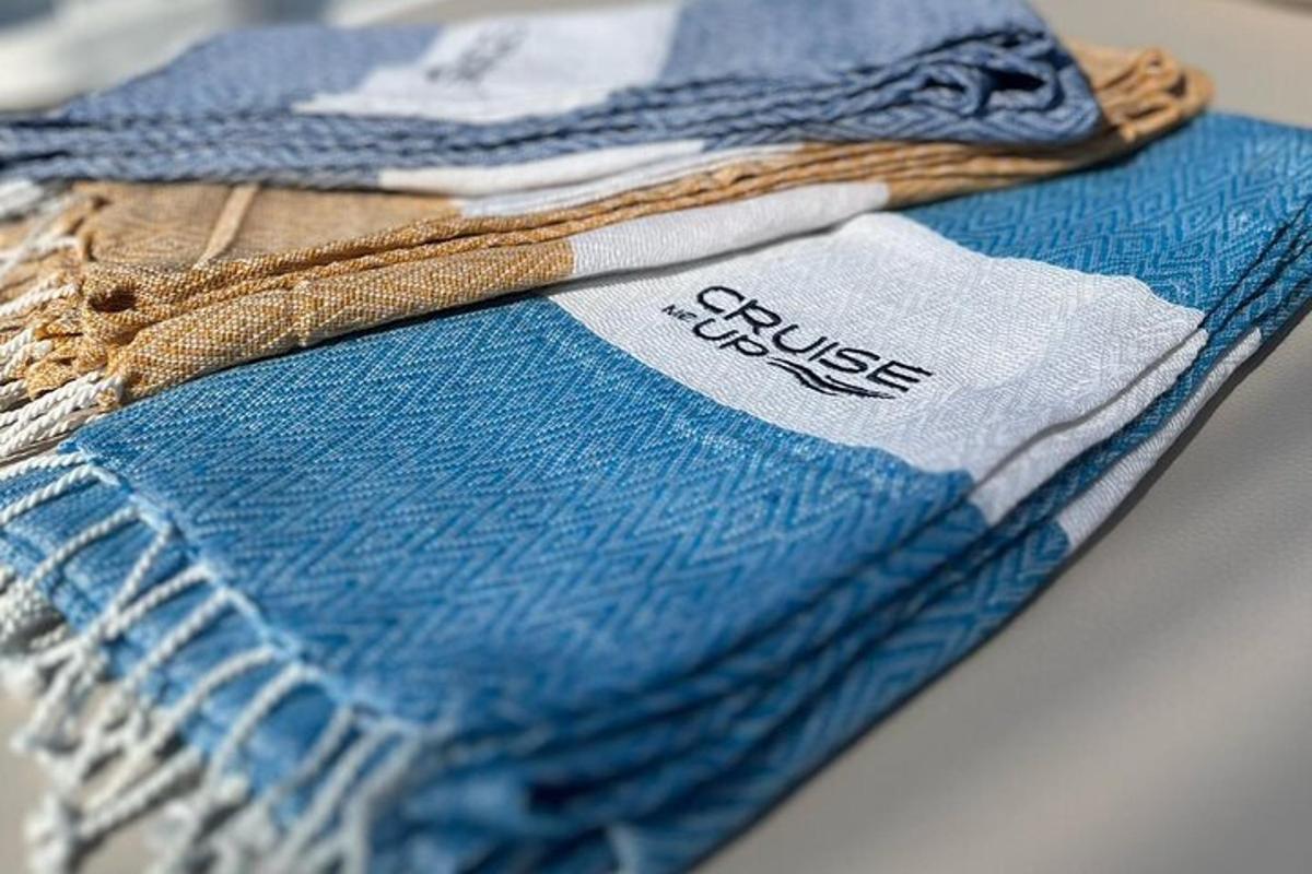 a pile of blue and white towels on a table