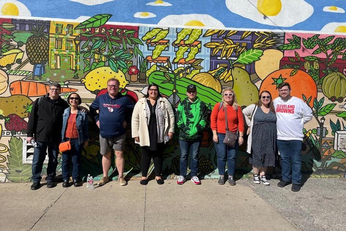 a group of people standing in front of a mural