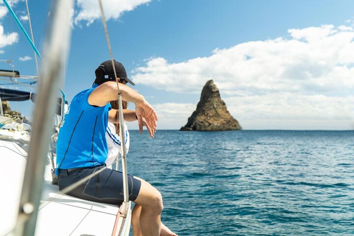 a man sitting on a boat in the ocean