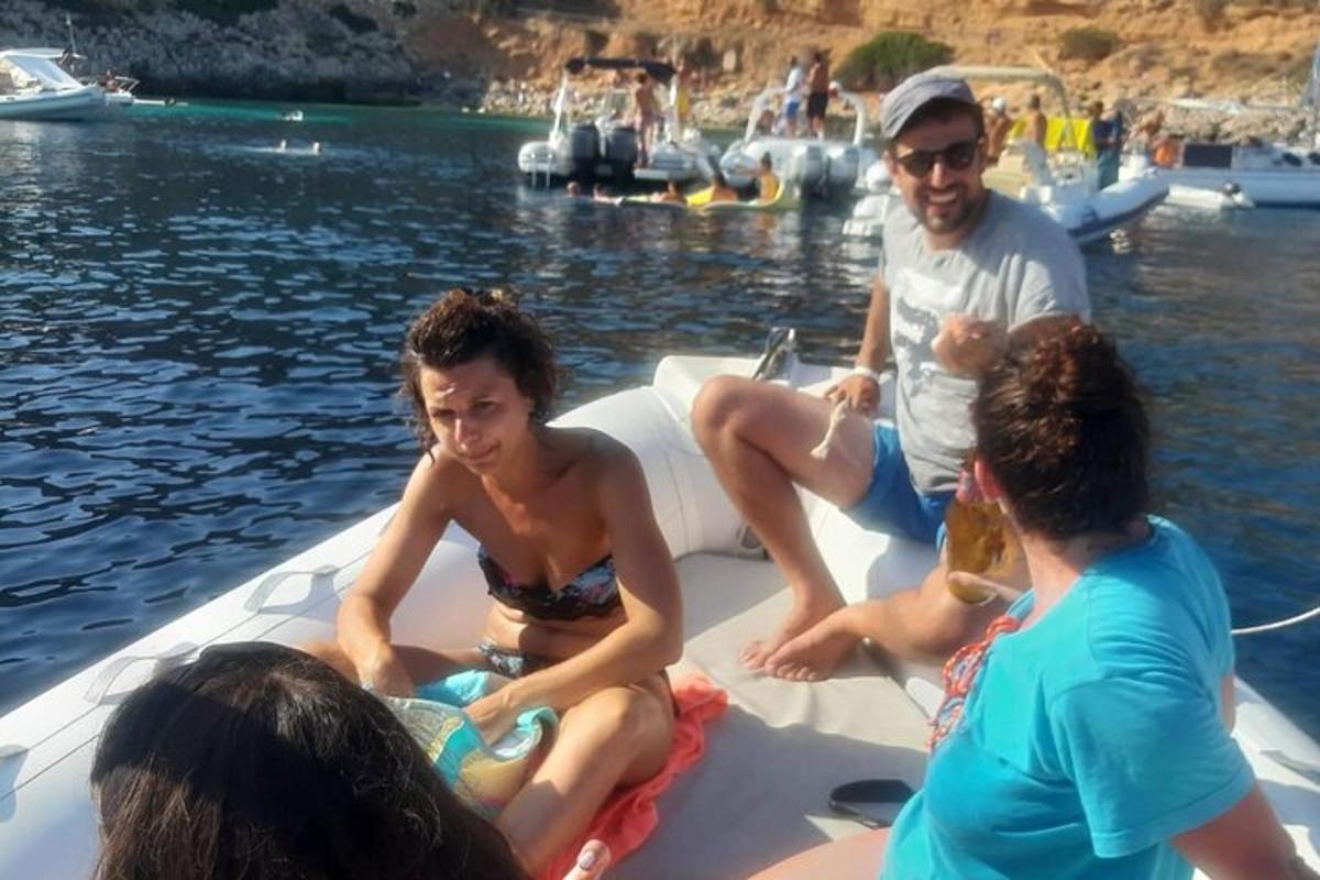 a group of people sitting on a boat in the water