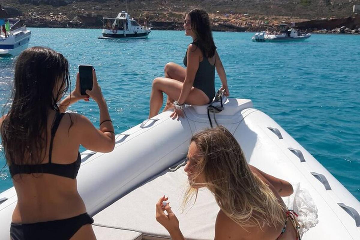 three girls in bathing suits on a boat in the water