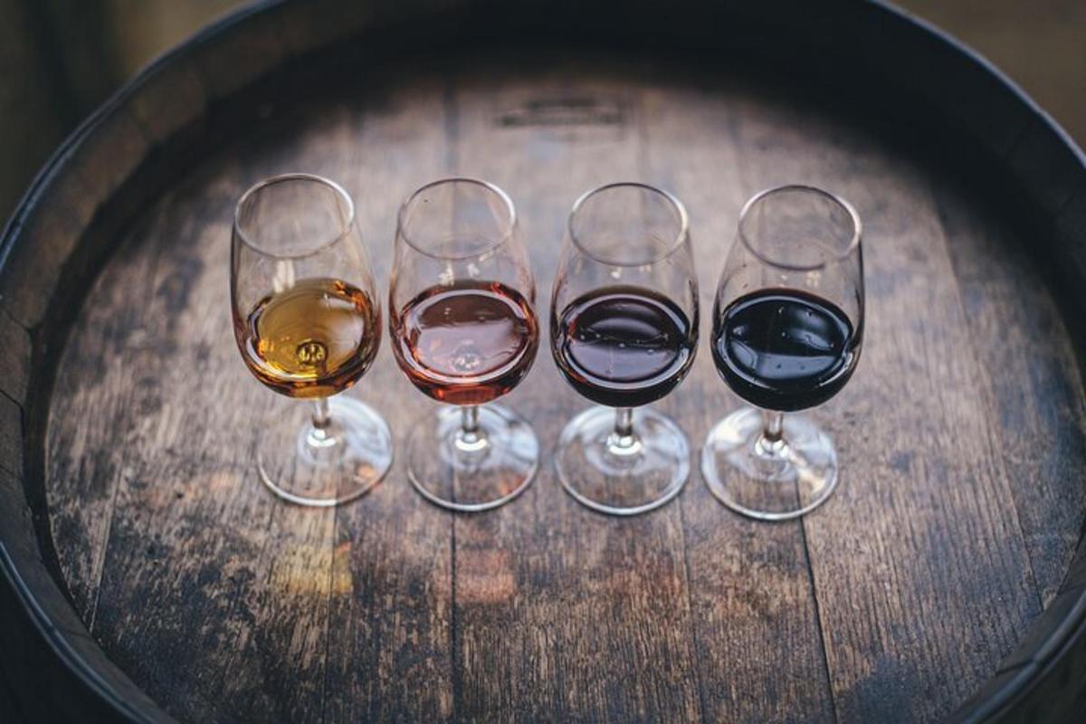 three wine glasses sitting on a wooden table