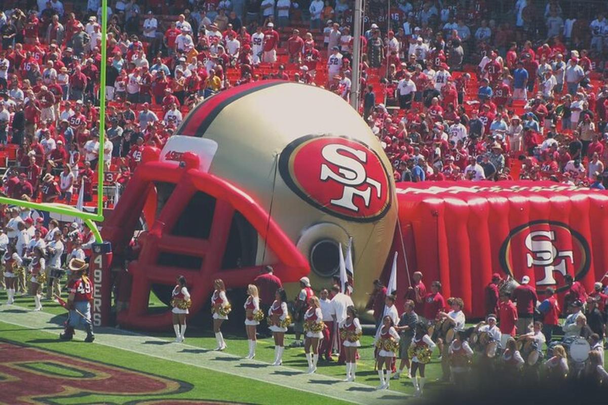 a large crowd of people watching a football game