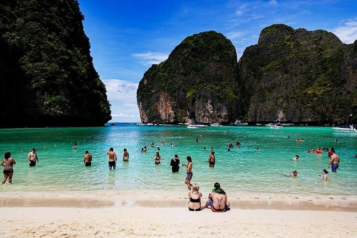 a group of people in the water at a beach