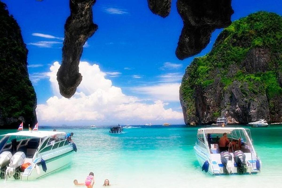 two boats parked on a beach in the water