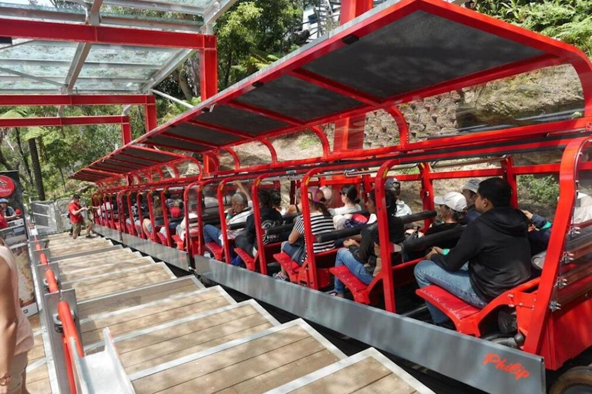 a group of people riding on a red train