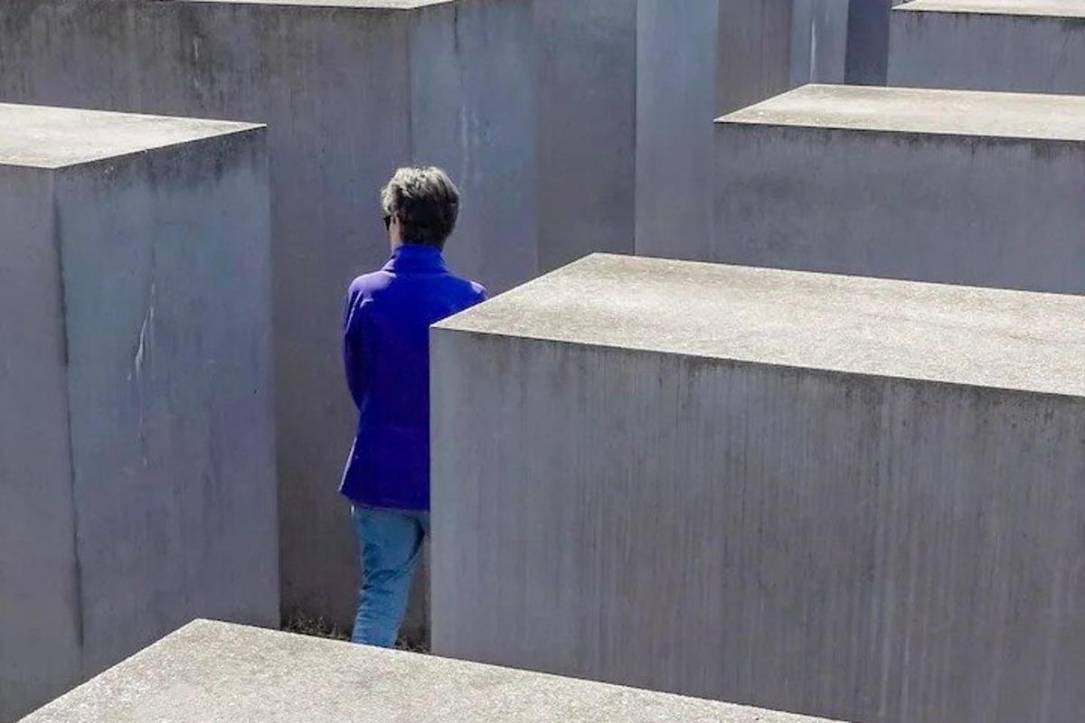 a man standing on the side of a wall