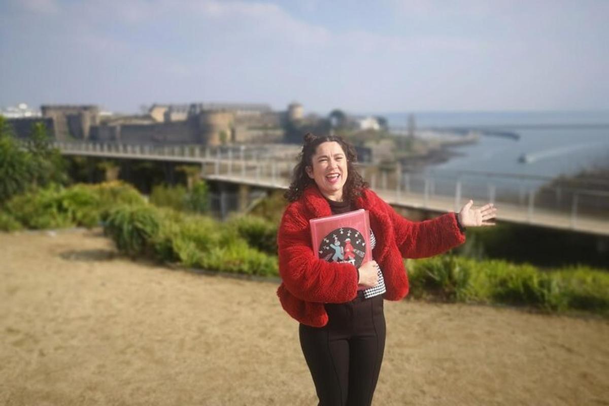a woman in a red sweater holding a book
