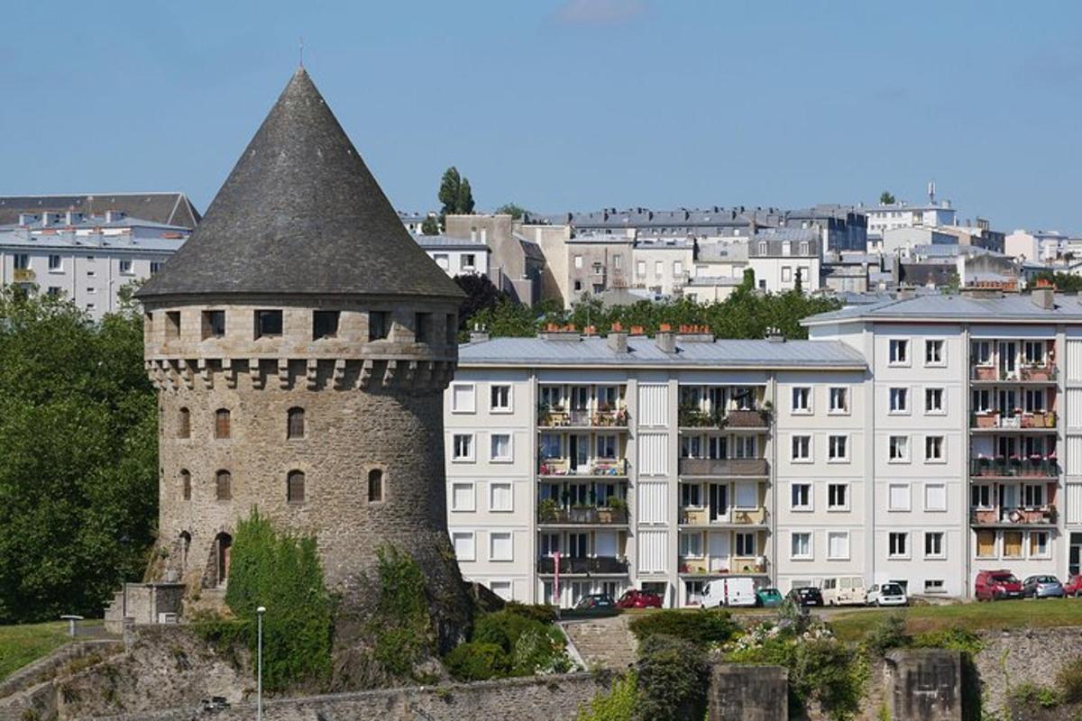 a building with a tower in front of a city
