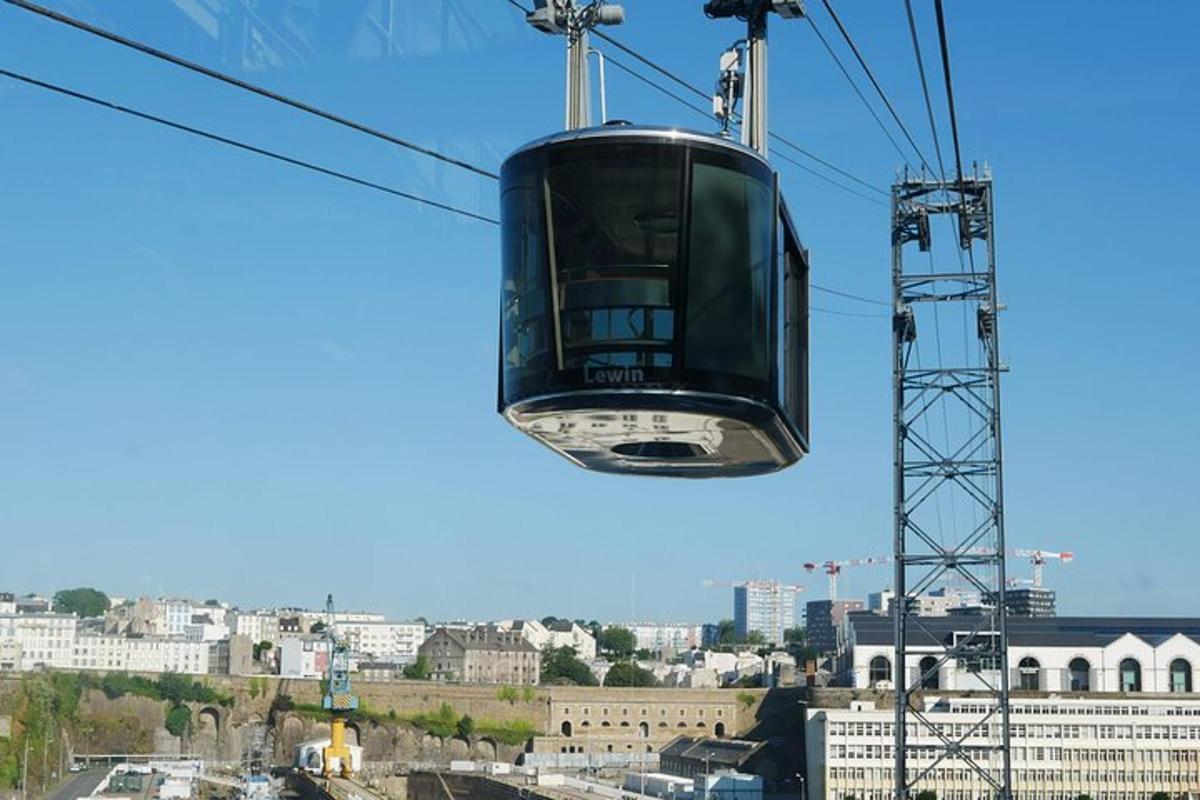 a cable car in the sky over a city
