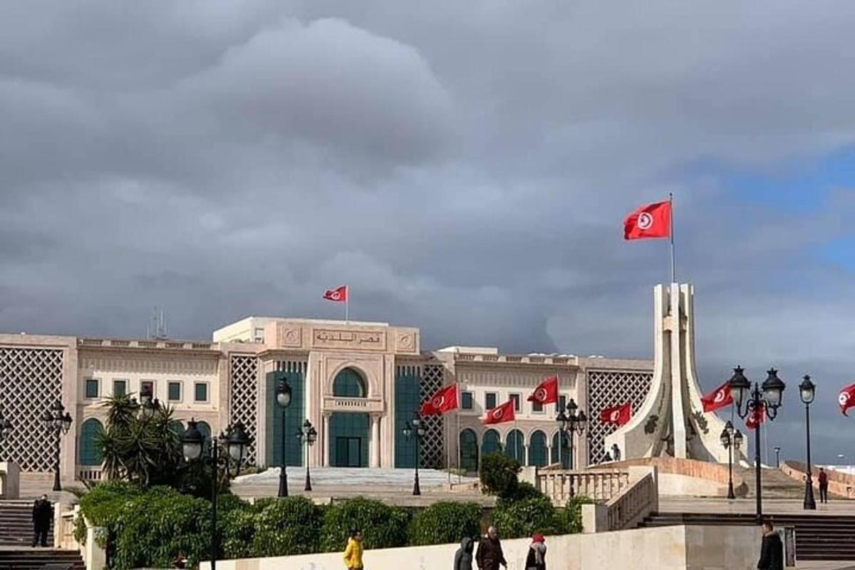 a large building with flags in front of it