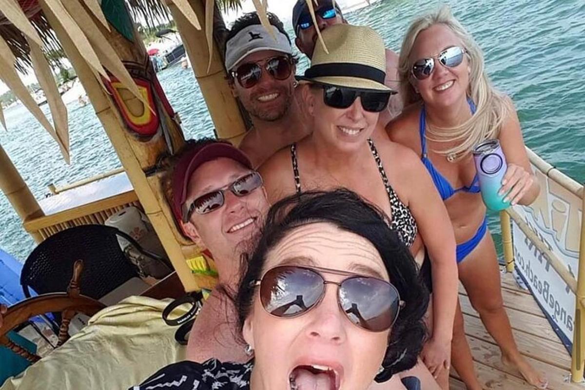 a group of people in bathing suits on a boat