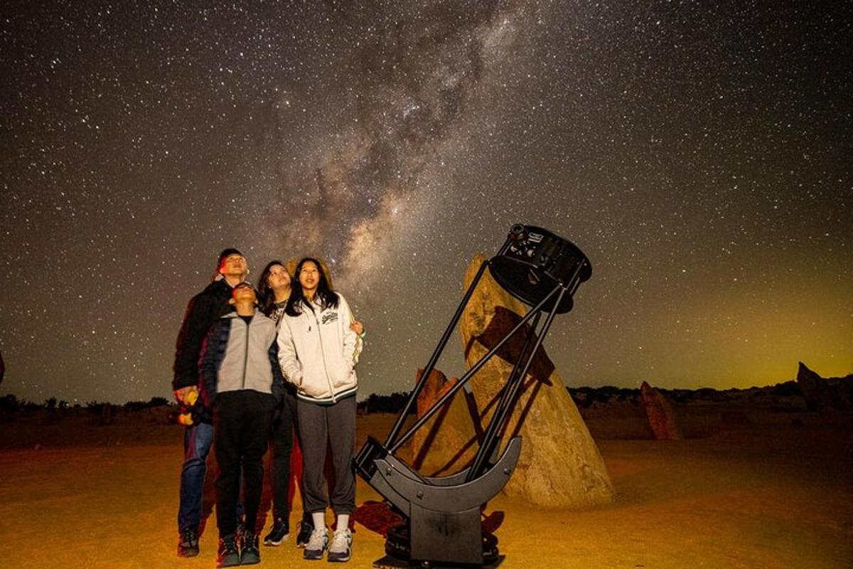 a group of people standing under the starry sky