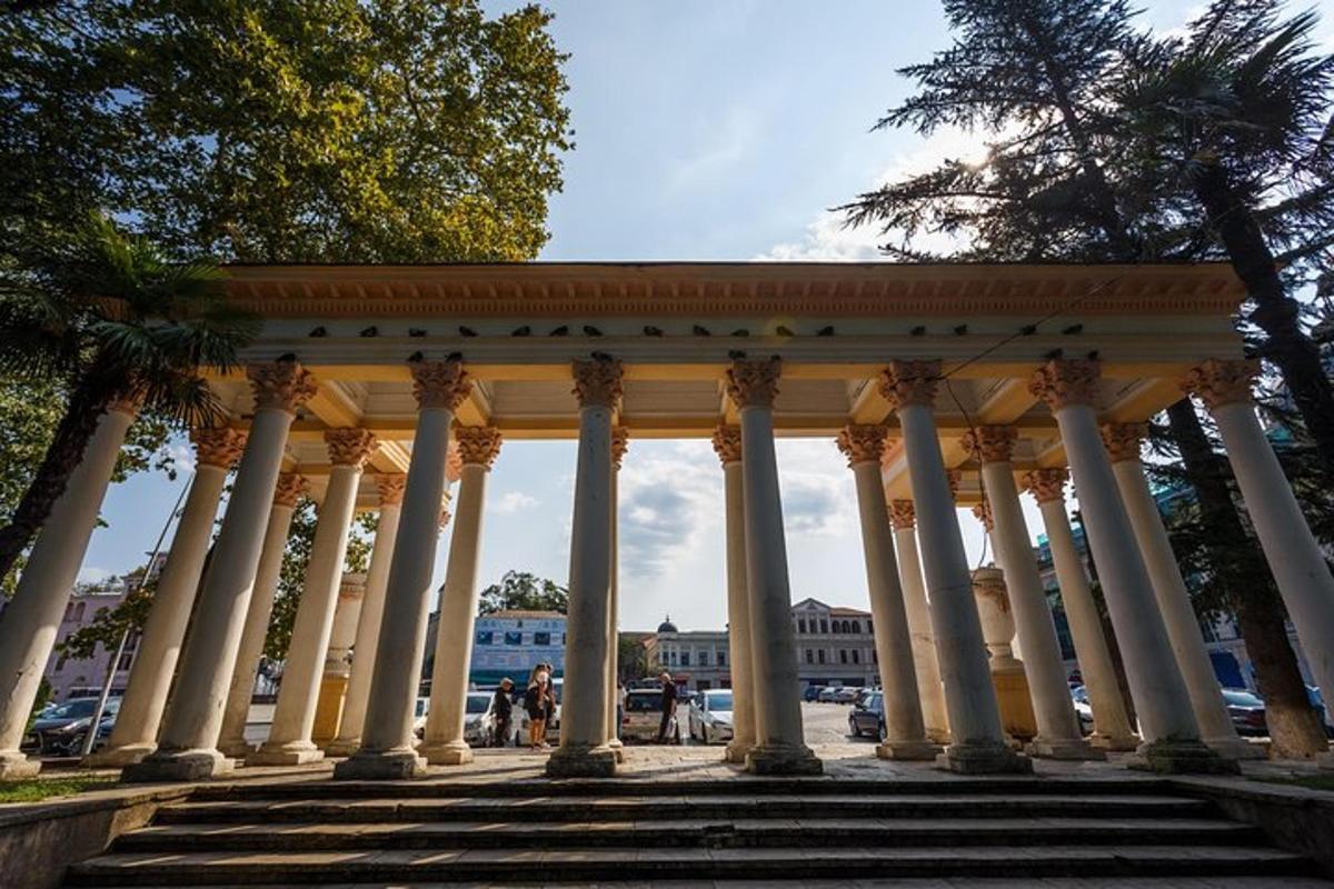 a building with columns and stairs in a city