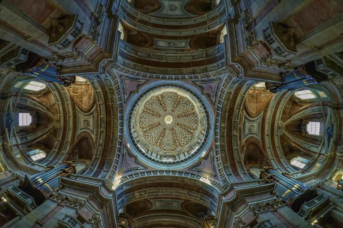 a ceiling of a building with a clock on it
