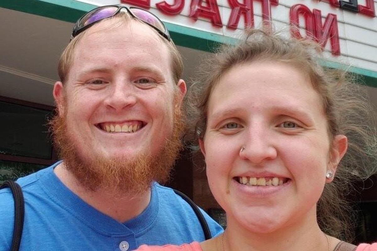 a man and a woman standing in front of a store