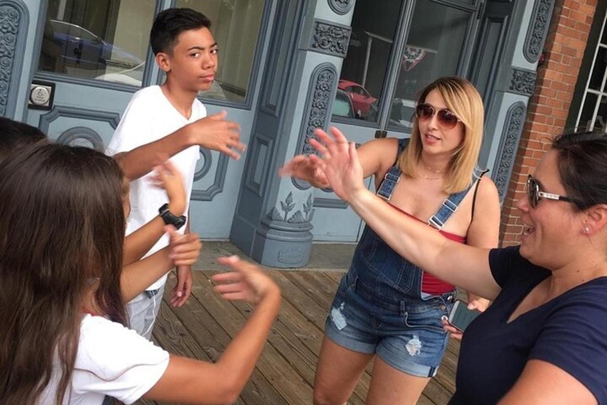 a group of people clapping in front of a building