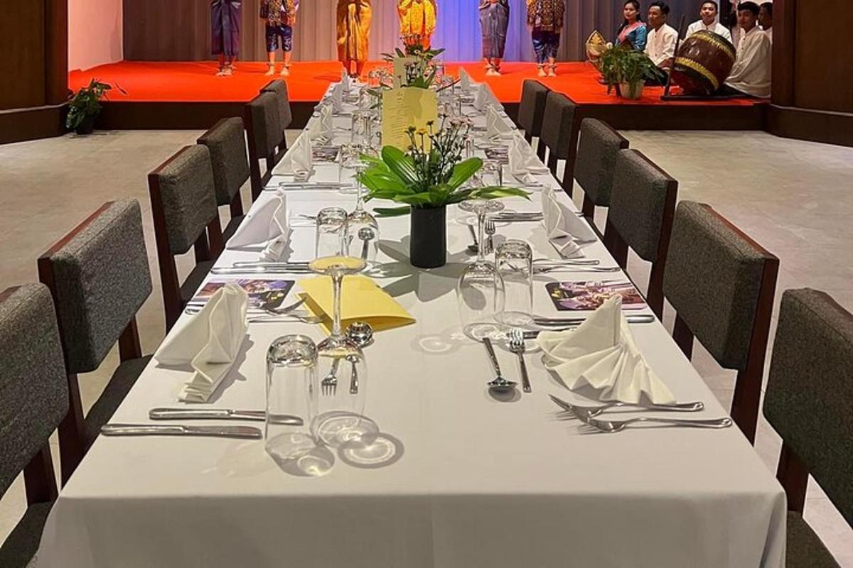 a long table with a white table cloth and silverware