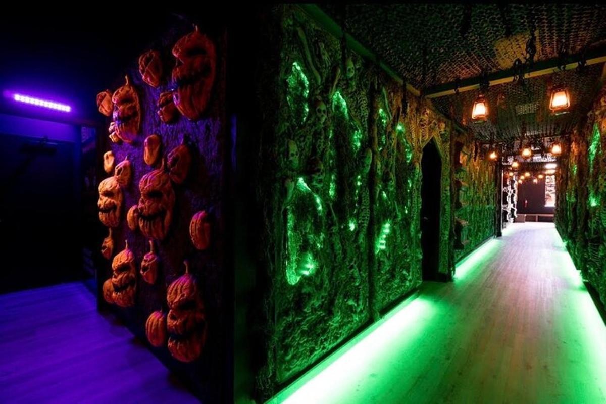 a dark room with a wall with green lights