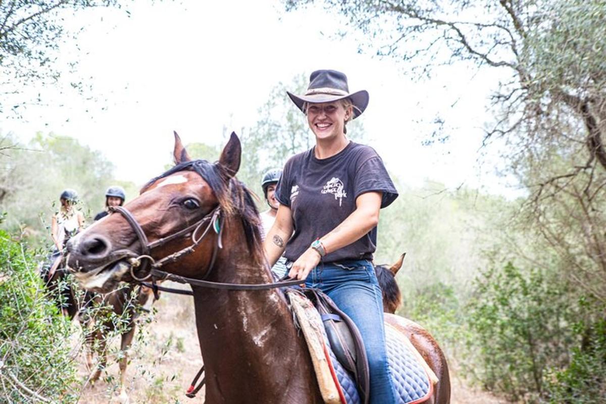 un hombre montado a caballo por un sendero