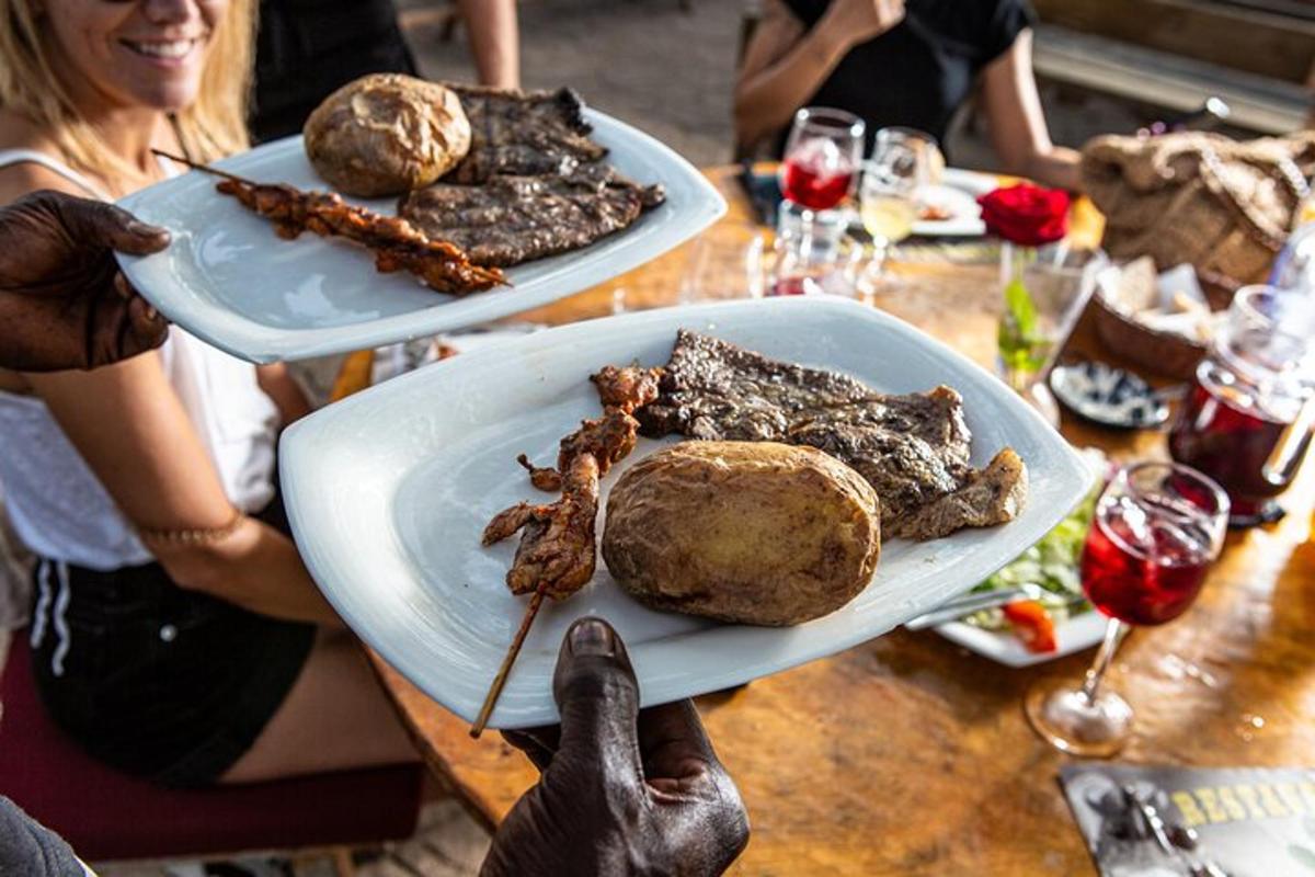 una persona que sostiene un plato de comida sobre una mesa