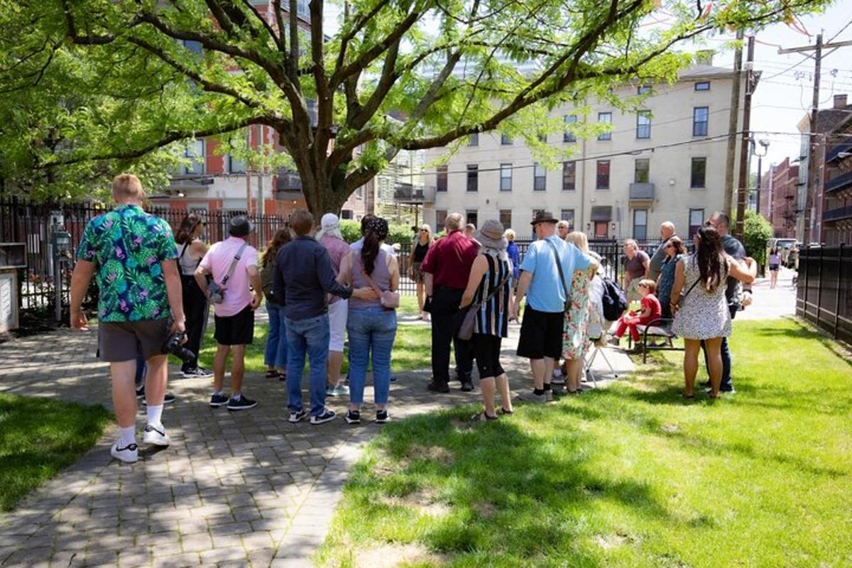 a group of people standing on a sidewalk