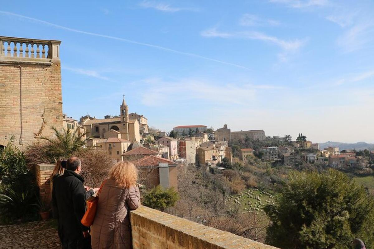 two people standing on a wall looking at a city