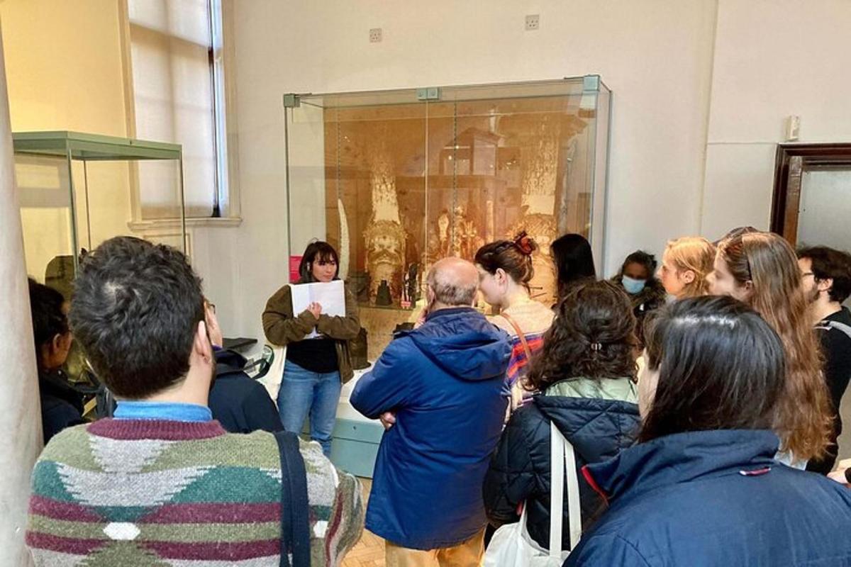 uma multidão de pessoas olhando para uma pintura em um museu