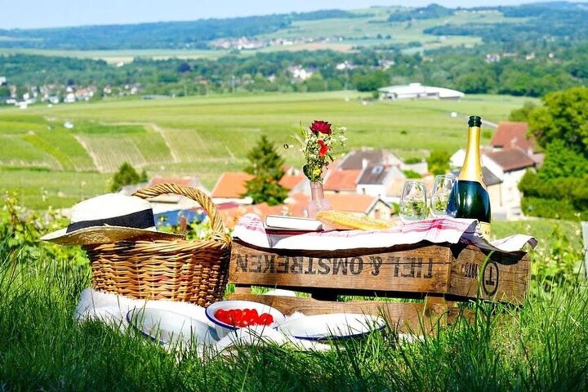 a picnic table with baskets and a bottle of wine