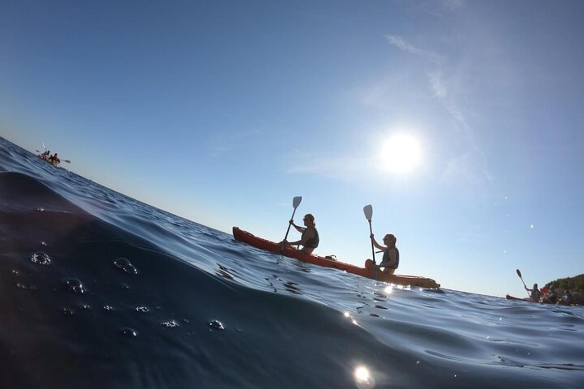 two people in a kayak on the ocean