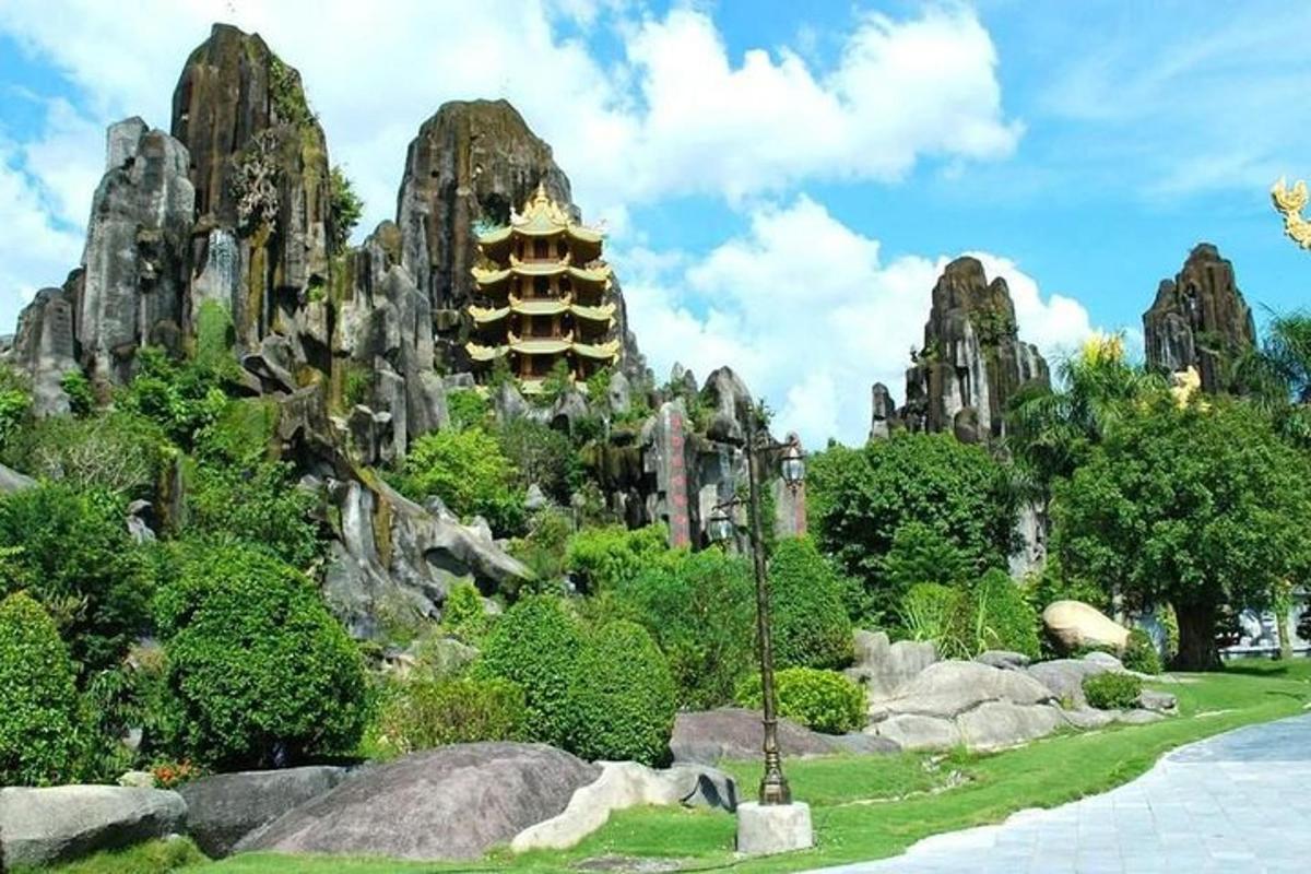a garden with rocks and a pagoda in the background
