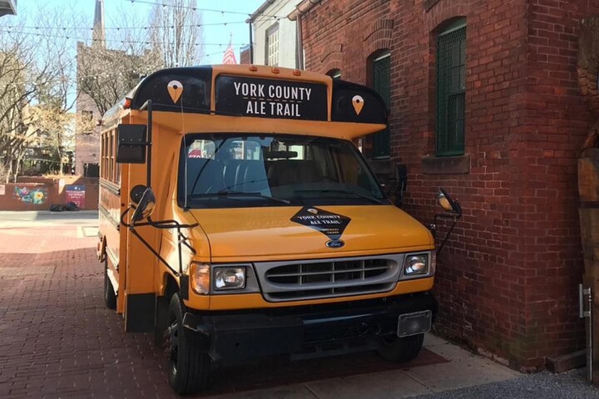 a yellow school bus parked next to a brick building