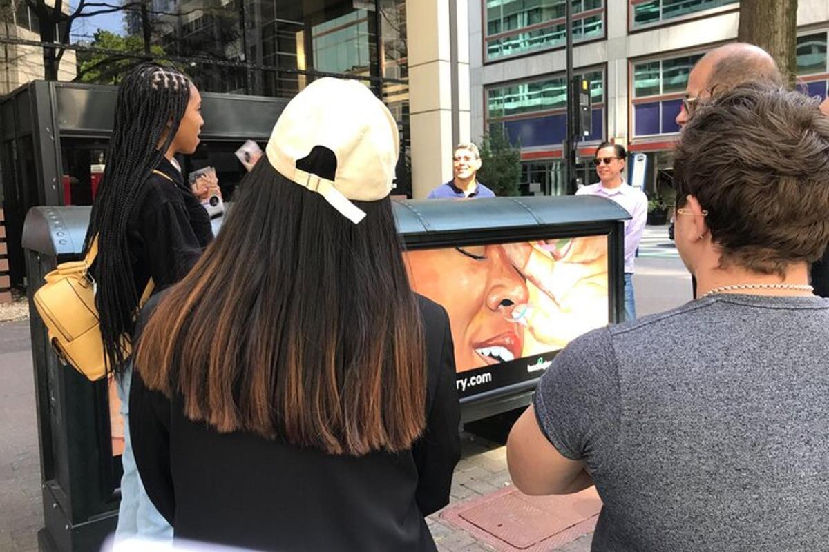 a group of people standing in front of a tv