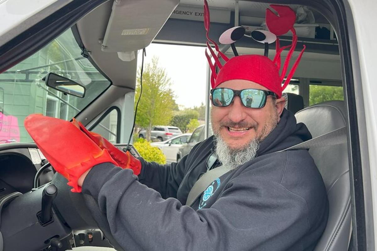 a man wearing a red hat and gloves in a car