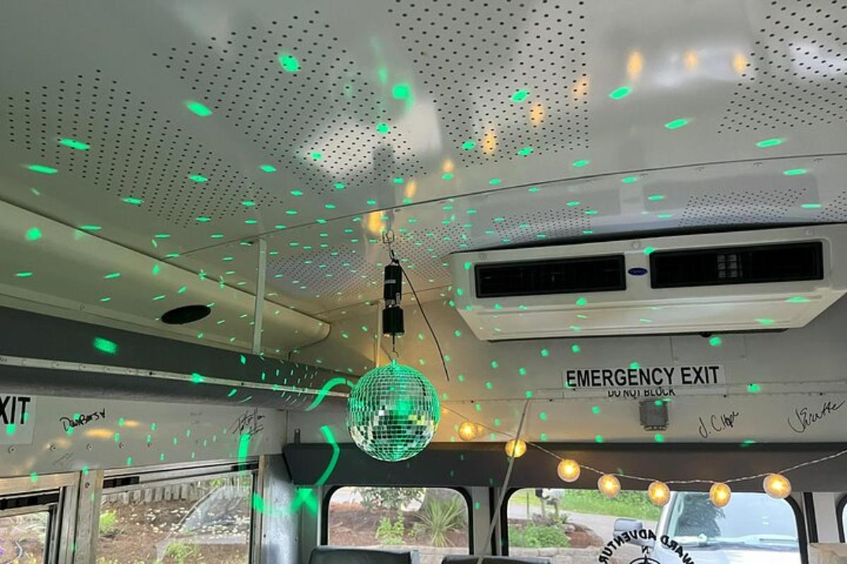 a bus with a disco ball hanging from the ceiling